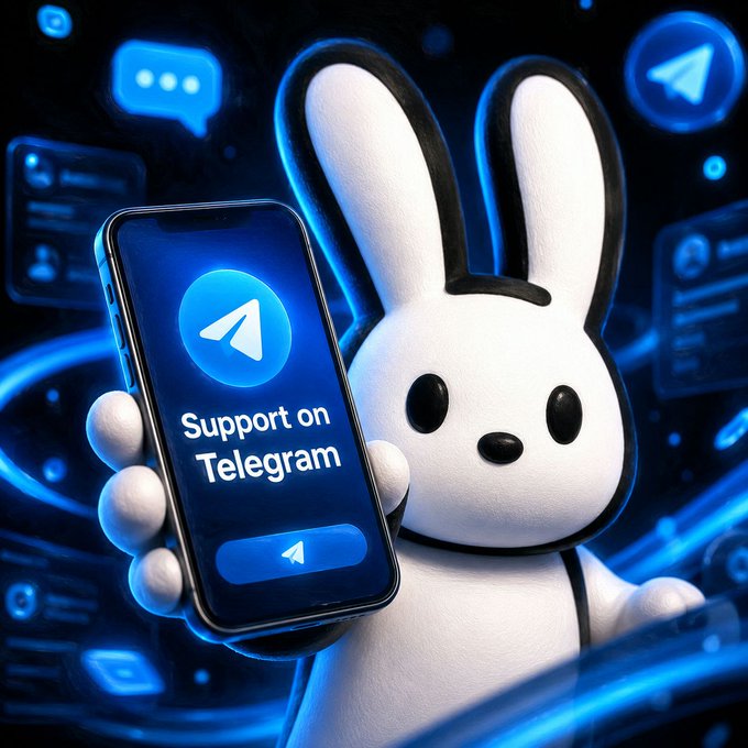 The image features a cartoon rabbit holding a smartphone, which displays a message about supporting Telegram. The rabbit appears to be holding the phone in its paws while standing against a black background filled with various social media icons such as Twitter, Facebook, and Instagram. The text on the phone reads "Support on Telegram", indicating that the rabbit is promoting the use of this messaging platform for communication and collaboration among users.
