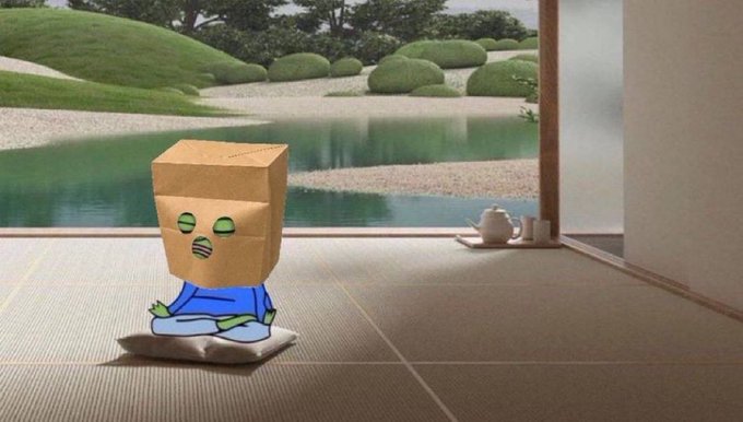 A digital illustration showing a small green-skinned character with a paper bag over its head, wearing a blue robe, sitting on a tatami mat and gazing at a Japanese zen garden with a pond and teacups.