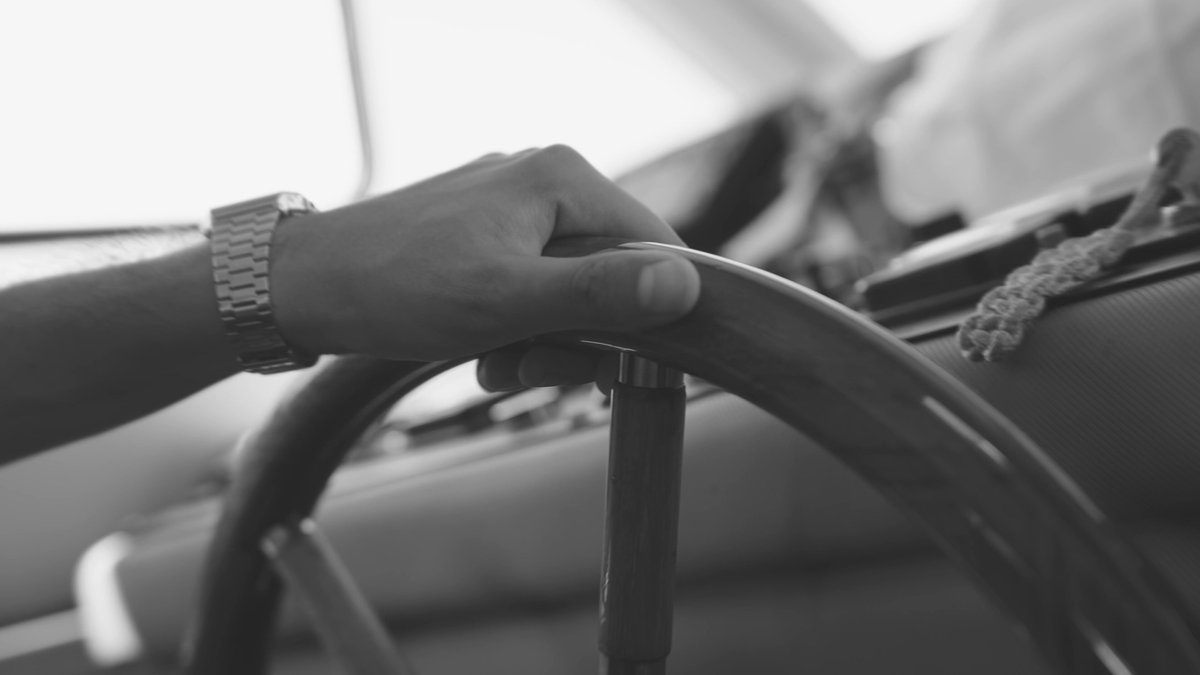 The image shows a person's hand holding onto a steering wheel of a car or boat. The scene takes place at night with a black and white filter, giving it an artistic touch. The caption reads "What a night to remember! @StellarOrg proved once again that its presence in Turkey is undeniable", indicating the event was a memorable one for the person who took the photo.