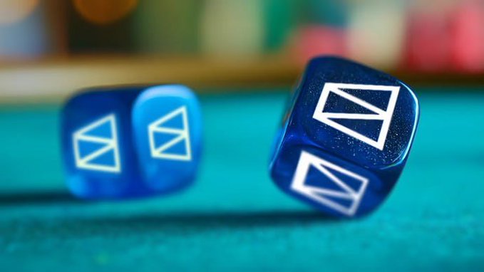 Two blue dice with a white envelope-like symbol on their faces, rolling on a teal surface.