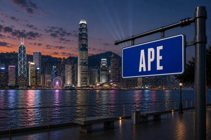 A dusk skyline of Hong Kong's Victoria Harbour with the Central district illuminated, featuring a prominent blue "APE" street sign in the foreground, tying into the post's greeting from Bored Ape Yacht Club ($APE) and the city's iconic skyscrapers reflecting on the water.