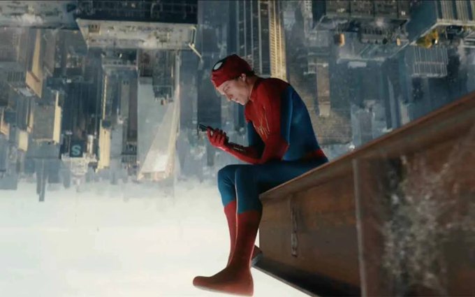 Spider-Man sits on a ledge high above a city, looking down at his phone. The image humorously evokes the post’s call to turn strategies into onchain agents, inviting people to join the Moss Tokenize Agent Competition S1 by the Aug 21, 12 PM UTC deadline for 500 Diamonds.
