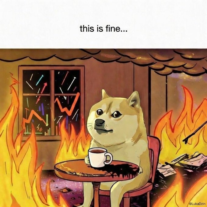 The image features a cartoon dog sitting at a table with a cup of coffee, surrounded by flames. The fire appears to be burning down a house or building nearby. The caption reads "This is fine... $DOGE". This suggests that the image is related to Dogecoin, which is a digital currency created in 2009 as a humorous response to the popular internet meme about a dog wearing a suit and hat.