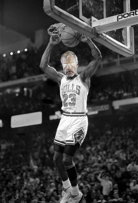 A black-and-white edited image shows an older man with a beard, wearing a white 'BULLS 23' basketball jersey, hanging on a basketball hoop with the ball going through the net in a crowded arena.