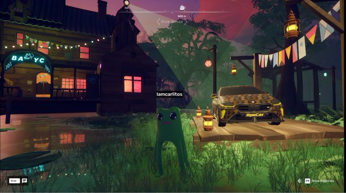 A green frog-like character named "lamcaritos" stands on grass in front of a golden "RyuCar" parked on a wooden dock, with a building labeled "BARNYC" and string lights visible in the background. The image depicts the FWOG character admiring the car in the OthersideMeta virtual world, matching the post's description of admiring the beauty of the vehicle.