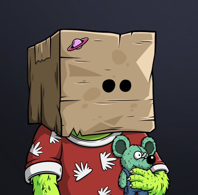 A cartoon character with a brown paper bag over its head—decorated with a small pink planet sticker—wears a red shirt patterned with white hands and holds a green teddy bear. The image illustrates the post's reference to a "monster" with a full mask and teddy bear, matching the playful description.
