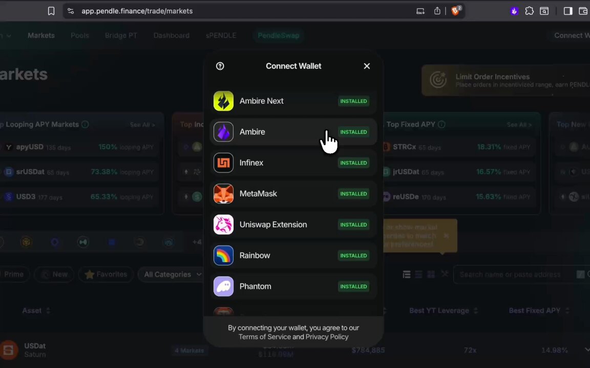 The image shows a computer screen displaying a website with various app icons, including one for a wallet application. A person's finger is pointing at the wallet icon, suggesting they are exploring or considering using the app. The background of the image is dark, which contrasts with the bright colors and icons on the screen.
