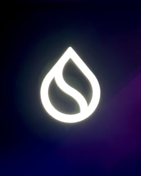 A glowing white teardrop-shaped logo with a leaf design inside, set against a dark purple and blue gradient background.