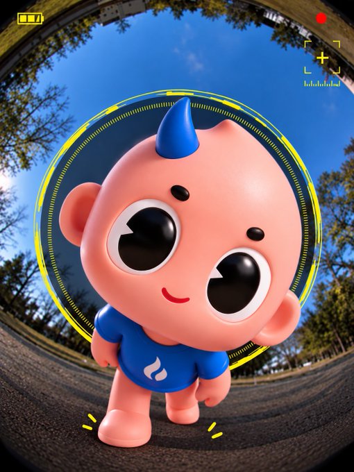 A 3D cartoon pink character with a blue horn and blue shirt with a flame logo, displayed through a camera viewfinder interface.
