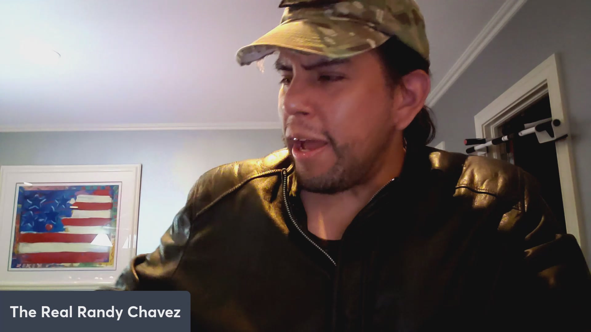 The image features a man wearing a hat, a jacket, and a leather jacket with his mouth open as if he's speaking or making a face. The caption of the image reads "VeVe crosses 700k revenue in May! $OMI $DEFX DACAT and LOKI news!". This suggests that the post is related to an advertisement for a product or service, possibly related to military gear or outdoor activities.

The man's facial expression and attire indicate that he might be discussing something related to his work or personal life in the context of the American flag image. The caption provides additional information about the content of the image, which is likely meant to catch viewers' attention and generate interest in the advertised product or service.