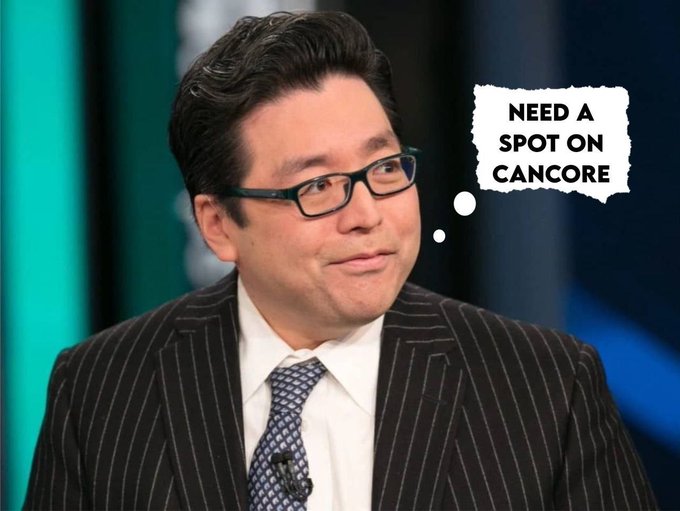 A man in a pinstripe suit and glasses on a television set, with a thought bubble reading 'NEED A SPOT ON CANCORE.'