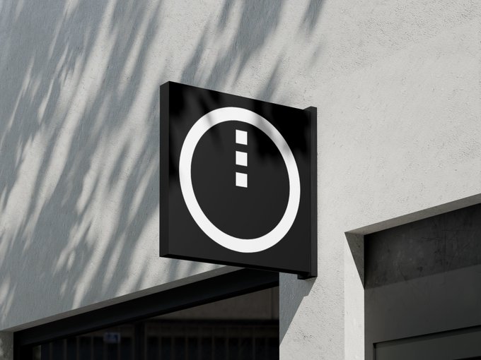 A black square sign mounted on a white building wall displays a minimalist logo featuring a white circle enclosing three vertically stacked white squares, casting shadows from nearby foliage. The geometric design visually reinforces the accompanying post's mention of the "Midnight" project and its native token $NIGHT, suggesting widespread adoption.