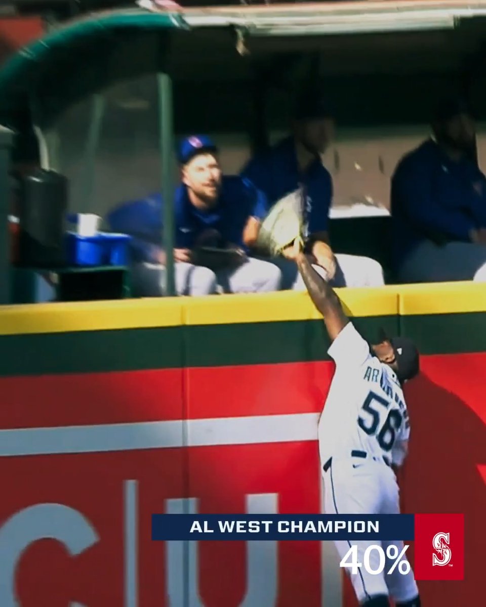 A baseball player wearing jersey #58 reaches up toward the railing of the opposing team's dugout, where a player in a blue uniform reaches out with a glove, seemingly attempting to catch or grab a ball. The graphic overlay reads "AL WEST CHAMPION 40%" with a Seattle Mariners logo, indicating the team's probability of winning the division as discussed in the post about the competitive American League West race.