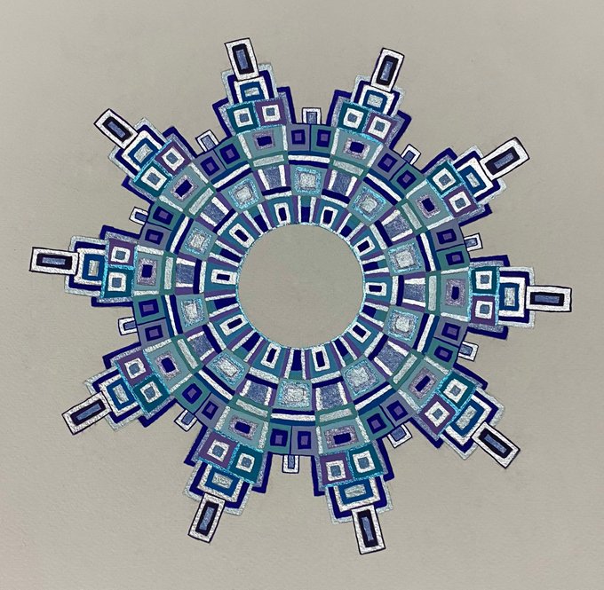 A geometric artwork featuring concentric rings of blue and teal squares radiating outward to form a circular mandala design.