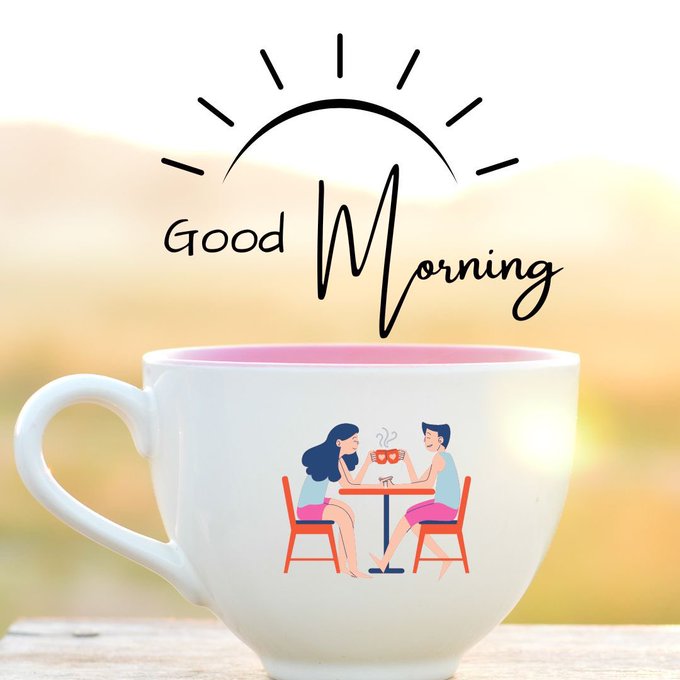 A white coffee mug featuring an illustration of a couple toasting at a table sits against a warm sunrise backdrop, with 'Good Morning' written in stylish script and a sun graphic above.