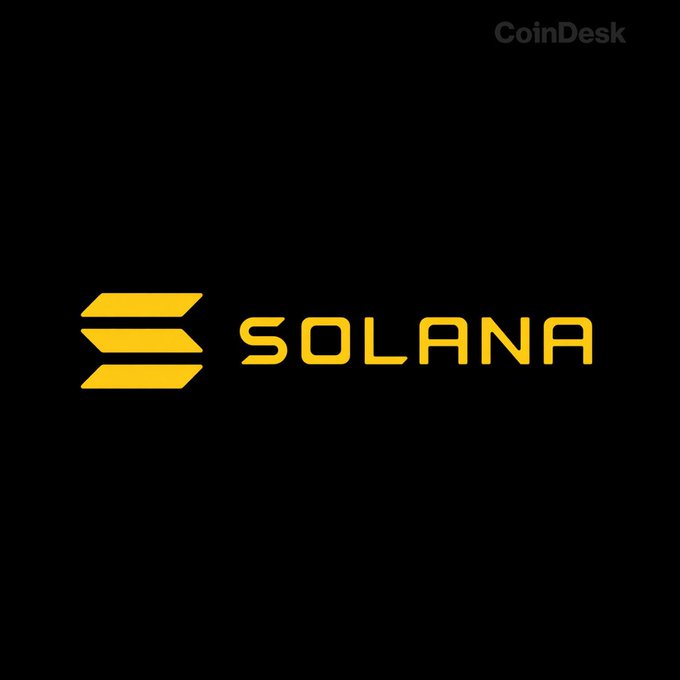 A black image displays the yellow Solana logo and wordmark “SOLANA,” with a faint “CoinDesk” watermark at the top right. It illustrates the post’s announcement that Solana has activated Alpenglow on mainnet, targeting 150 ms finality—about 40× faster than TowerBFT’s 12.8 seconds.