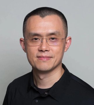 A professional headshot of an Asian man with short dark hair, wearing rimless glasses and a black collared shirt, photographed against a plain light gray background. The image appears to be a corporate or editorial portrait, likely accompanying news coverage of the BNB Chain Layer 1 development announcement, possibly depicting a company executive or spokesperson quoted in the story.