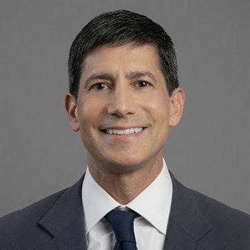 This image features the smiling face of a man in a suit and tie. He is likely a subject of "THE BLOCK" article discussing the Federal Reserve's decision on interest rates and its impact on cryptocurrencies like XRP.