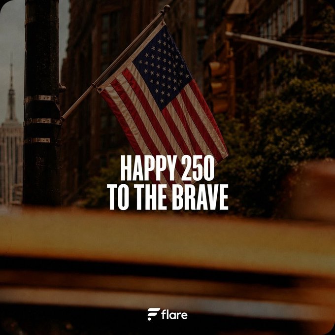 An American flag waves on a city street with the Empire State Building visible in the background, overlaid with bold white text reading "HAPPY 250 TO THE BRAVE" and the "flare" logo in the bottom right corner. The image visually celebrates America's 250th anniversary, tying into the post's milestone message from Flare.