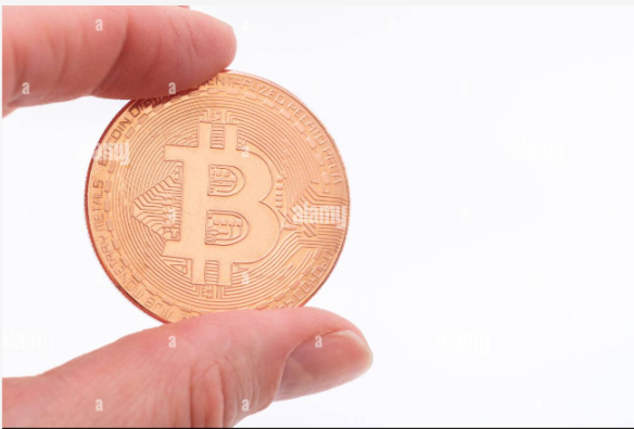 A hand holds a copper-colored Bitcoin coin against a white background, with the "₿" symbol and text "DIGITAL • DECENTRALIZED • PEER TO PEER • BITCOIN" visible. The image illustrates the post's reference to the withdrawal of 4,000 BTC (over $300 million) from the Liquid exchange, reportedly accompanied by a message claiming to be from white hat hackers.