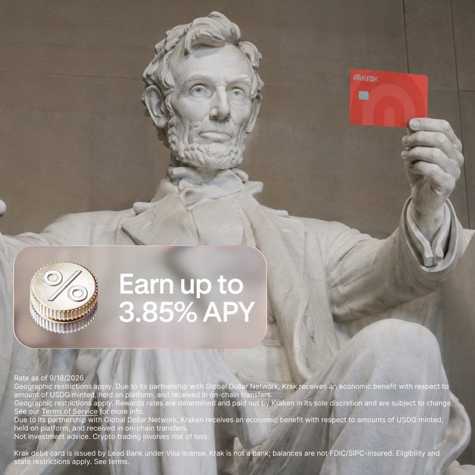 Abraham Lincoln's statue at the Lincoln Memorial holds a red Kraken debit card, promoting Kraken's USDG product offering up to 3.85% APY (rate as of 9/18/2026) on held balances.
