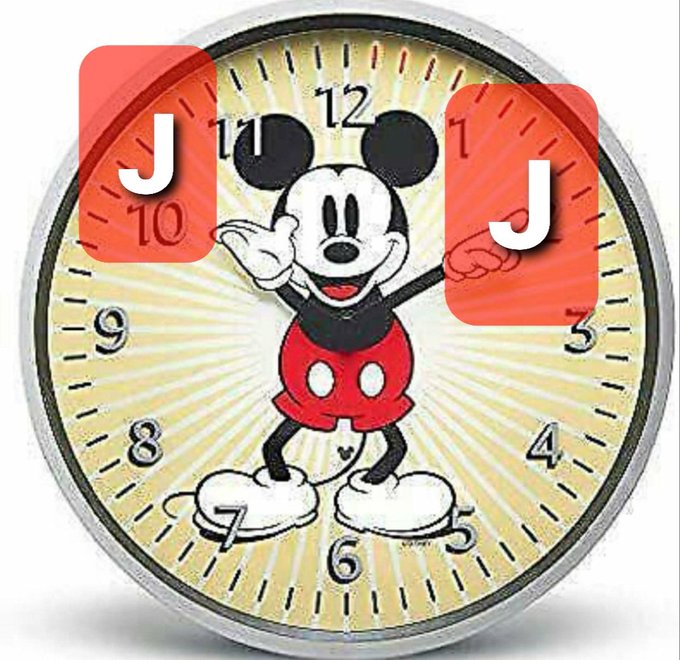 A Mickey Mouse-themed clock face with two red Joker playing cards overlaid on the upper corners showing the letter 'J'.