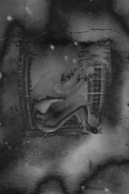 This image depicts an abstract composition featuring a person's face hidden behind a patterned rug. The central figure appears to be a newborn child, with a soft and vulnerable expression as they gaze into space. The background is filled with black and white elements, giving the scene a dreamlike quality. The image seems to convey a message about the importance of connecting past and present in life, drawing inspiration from the phrase "The well of stars" which implies that our past experiences shape who we are today. It also uses the imagery of a newborn child as a symbol for new beginnings and growth.