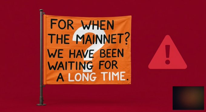 An orange flag on a pole displays the text 'FOR WHEN THE MAINNET? WE HAVE BEEN WAITING FOR A LONG TIME.' against a dark red background, accompanied by a warning triangle icon.