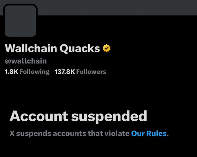 The image shows a black background with a Twitter post that reads "BREAKING: Wallchain's account is suspended". This message indicates that Wallchain's account has been suspended, possibly due to violating certain rules or policies. The post also mentions that the suspended account will be sent an email shortly after being suspended.