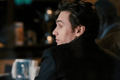 iced tea and a glass of water on the bar counter, with a man's head turned to the side.