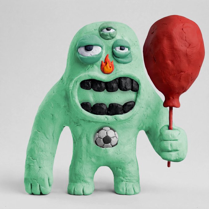Sculpture of a green, three-eyed claymation-style monster holding a large red boxing glove-shaped club, featuring a small flame nose and a soccer ball belly button.