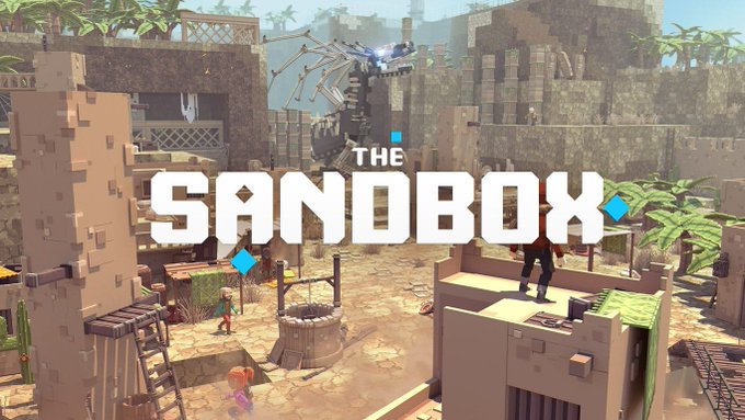 "The SANDBOX" logo prominently displayed over a blocky, voxel-based 3D game environment with characters and a desert village scene.

The image shows The Sandbox's branding and voxel-style game world, visually representing the platform currently affected by a reported exploit where attackers have allegedly minted ~15B unbacked SAND tokens by hijacking LayerZero delegate permissions, according to PeckShield.