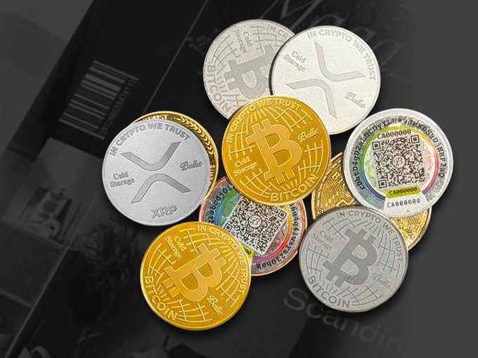 Photograph of physical commemorative coins representing XRP, Bitcoin, and other cryptocurrencies, each marked 'Cold Storage' and 'In Crypto We Trust' with QR codes.