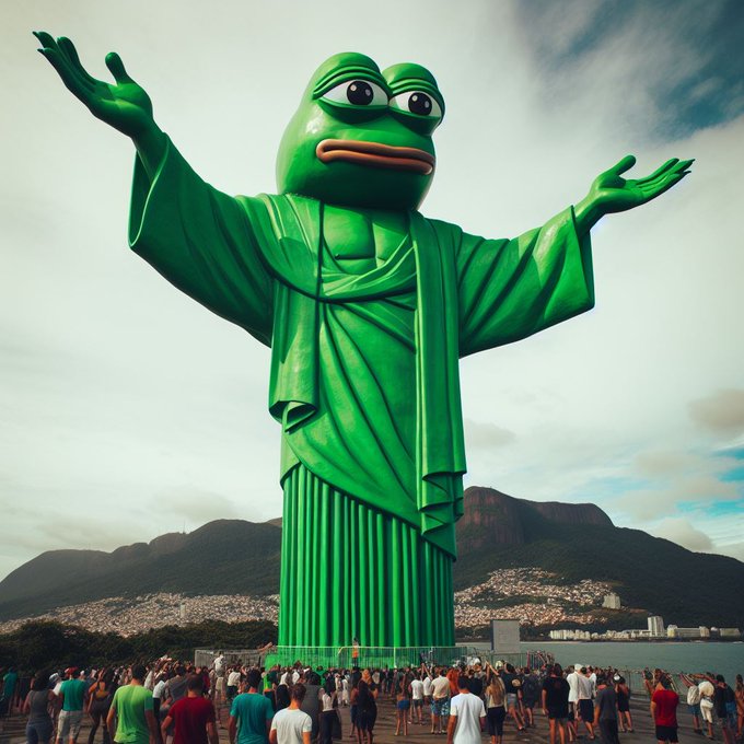 An image of a giant green Pepe the Frog statue styled like Christ the Redeemer, with arms outstretched, overlooking a crowd of people near a coastline.
