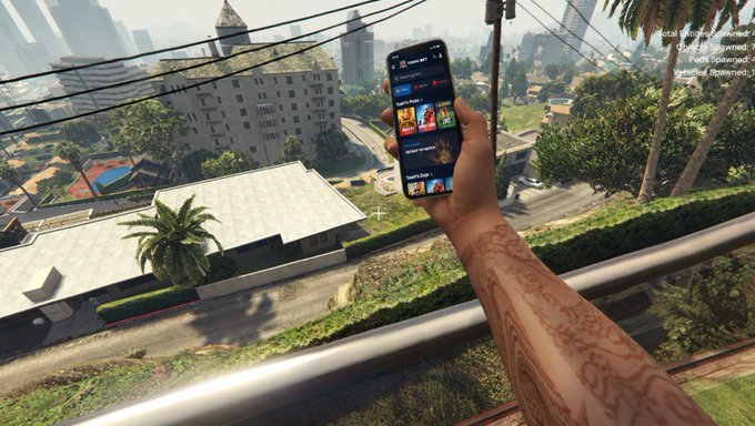 A first-person view from a video game showing a tattooed arm holding a smartphone with the Opera browser interface open, overlooking houses and a city in the background.