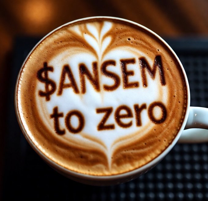 A close-up view of a latte in a white cup where the foam art cleverly spells out the phrase '$ANSEM to zero' in brown, framed by a heart-shaped latte art design.