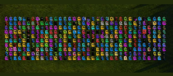 An aerial view of numerous colorful racing karts arranged in neat rows on a grassy field.