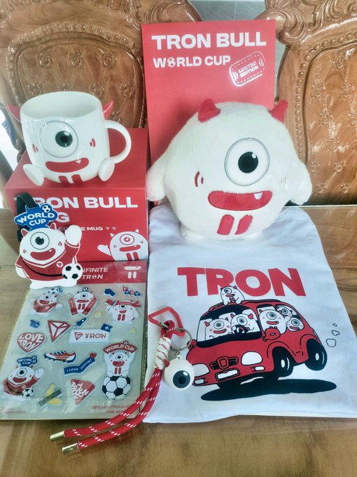 This image displays a collection of TRON BULL World Cup merchandise, including a mug, plush toy, t-shirt, stickers, and keychain, all featuring the TRON BULL mascot. The items are presented as part of a limited edition set to the Vietnamese community.