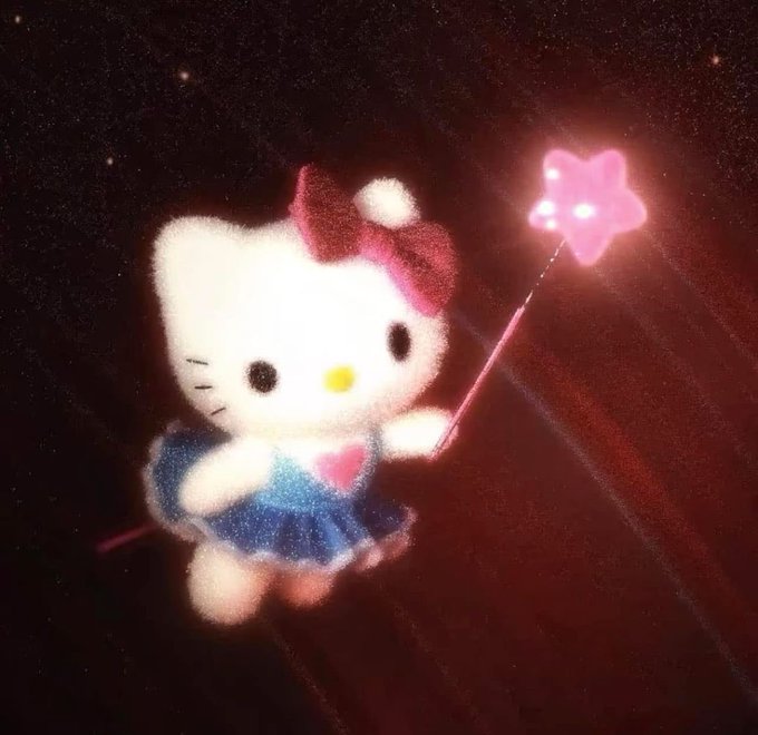 A glittery, dreamlike image shows Hello Kitty dressed in a sparkly blue outfit with her iconic red bow, holding a glowing pink star-shaped wand against a dark, cosmic background—evoking the magical, meme-worthy charm of the "$kitty" crypto token being dubbed "the people's cat."