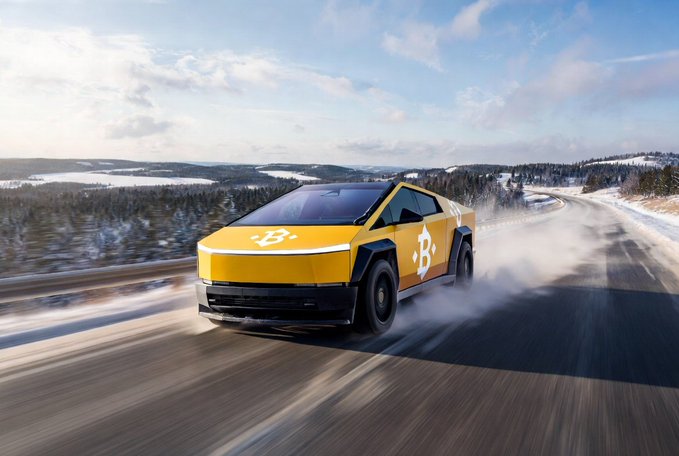 A yellow Bitcoin-branded Tesla Cybertruck driving on a snowy road with a forested mountain landscape in the background.