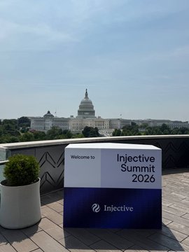 A welcome sign for "Injective Summit 2026" sits on a rooftop terrace with the U.S. Capitol dome visible in the background, marking the final preparations ahead of the Injective Summit event.