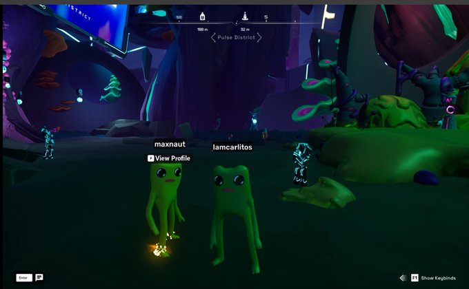 Two green FWOG characters, labeled "maxnaut" and "lamcarlitos," stand together in the vibrant "Pulse District" of the OthersideMeta virtual world, matching the post's playful reference to FWOGS. A "View Profile" prompt appears above one character, highlighting the social, avatar-based nature of the metaverse scene.