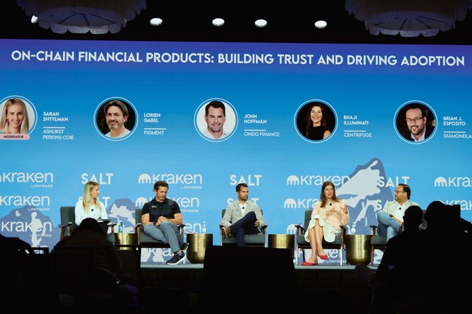 A panel discussion at the SALT conference on 'ON-CHAIN FINANCIAL PRODUCTS: BUILDING TRUST AND DRIVING ADOPTION' featuring speakers Sarah Shulman, Lorien Gabel, John Hoffman, Bhaji Illuminati, and Brian J. Esposito, with Kraken as a sponsor.