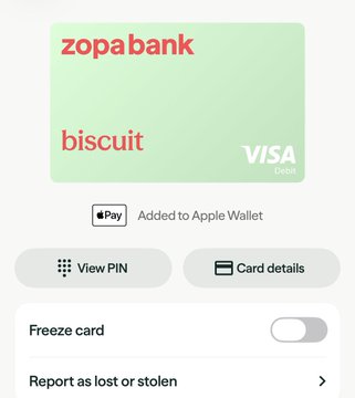 The image shows a digital Zopa Bank debit card in Apple Wallet, labeled "biscuit" with "VISA Debit" branding, featuring options to view PIN, view card details, freeze the card, and report it as lost or stolen, suggesting the user has successfully activated their physical Zopa debit card and added it to Apple Pay, which aligns with the post's mention of Zopa issuing physical cards after previously deactivating many unactivated ones.