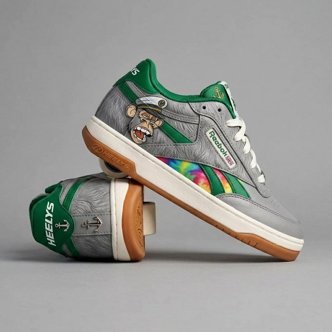 A pair of gray and green sneakers featuring a cartoon sailor face, an anchor, and 'HEELYS' branding with 'Freedom Moses' text, displayed on a gum sole.