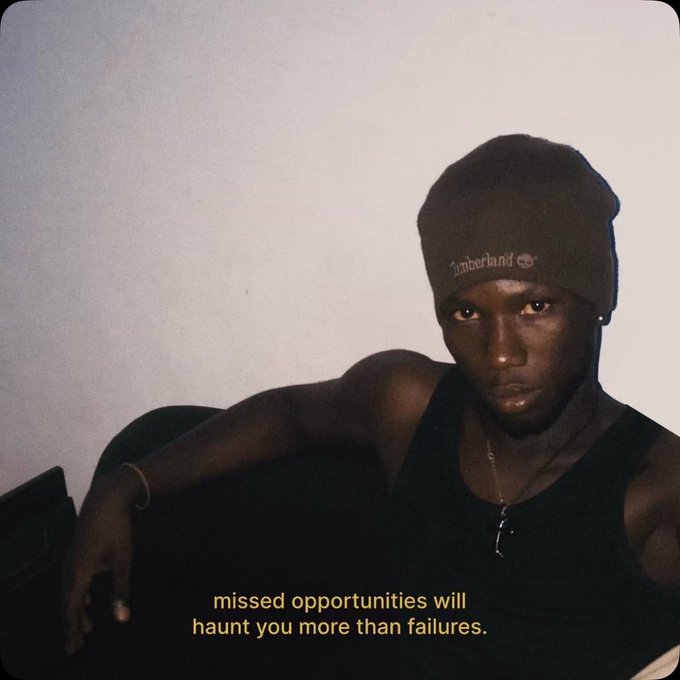 A young man wearing a dark beanie and black tank top looks directly at the camera in a dimly lit setting, with the caption 'missed opportunities will haunt you more than failures' displayed below.