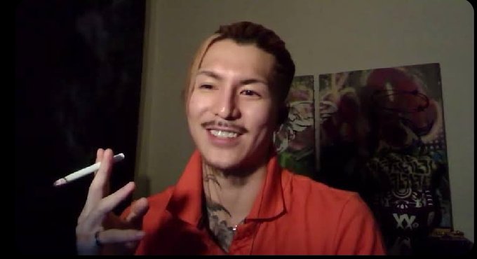 A man in a red shirt smiles while holding a vape pen, with the post's "GM gQuip" message and @quipnetwork branding suggesting he may be a casual, everyday crypto/Web3 enthusiast promoting the platform's communication-focused mission.
