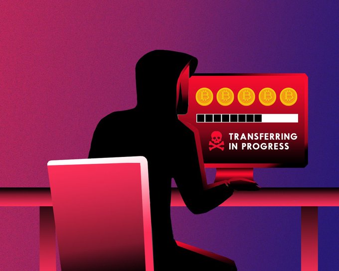 A digital illustration of a hooded hacker silhouette at a computer with a red screen showing Bitcoin icons, a loading bar, and a skull symbol with the text "TRANSFERRING IN PROGRESS."