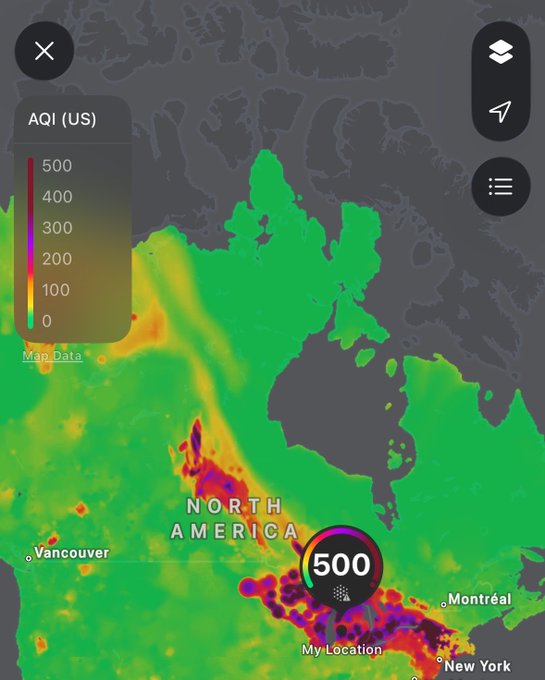 An air quality index (AQI) map of North America shows a reading of 500 (the maximum "hazardous" level) at the user's location near New York and Montréal, with surrounding areas displaying purple and red zones indicating severe pollution—poking fun at the dangerously poor air quality with the quip "Guess I just won't breathe today."