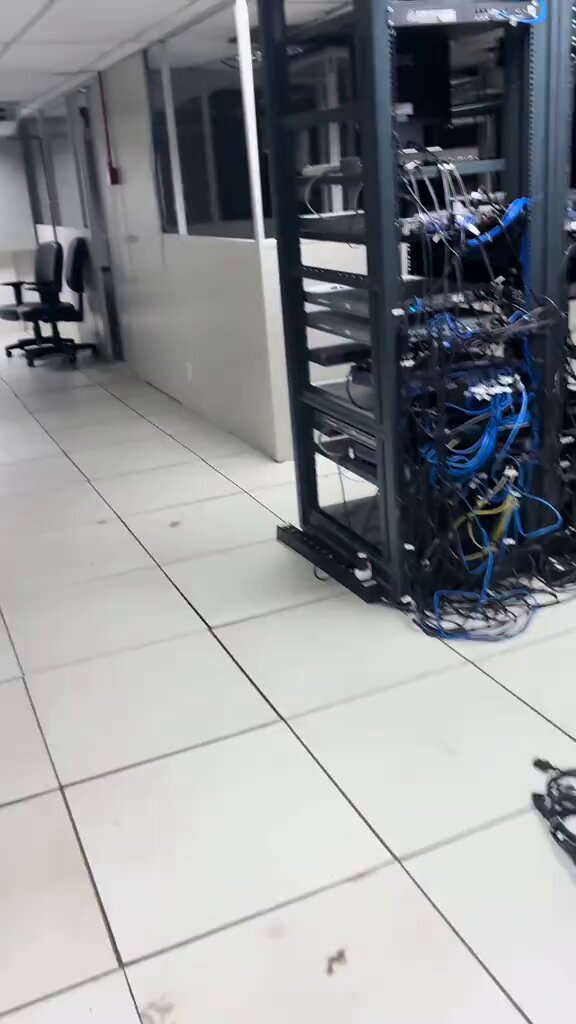 The image shows an empty, white server room filled with various cables and wires attached to multiple equipment such as servers, laptops, and routers that are placed throughout the space. The room appears to be a server room or data center, as indicated by the abundance of electronics and electronic devices within it. There is also a desk in the room, possibly for someone to manage or maintain the equipment. The caption related to this image reads: "TAO LUNG SPENT $2 MILLION ON A KIMI K2.6 SERVER ROOM. NOW THE $199 VIVACE PLAN COSTS HIM $0 AND HE PAYS $10 IN ELECTRICITY tao got tired of paying". The image provides context about the server room, equipment, and its costs, as well as an explanation of why the owner decided to switch plans.